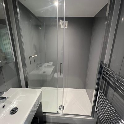 Modern bathroom renovation featuring sleek fixtures and tiled walls by iGroup South West Ltd
